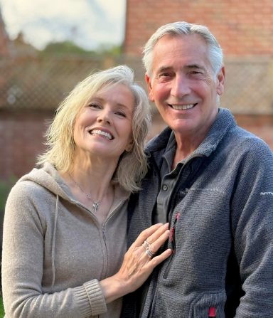 Smiling mature modelling couple in casual outdoor portrait