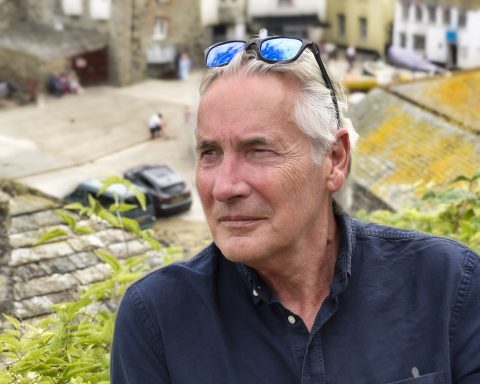 Mature male model in casual portrait outdoors with thoughtful expression