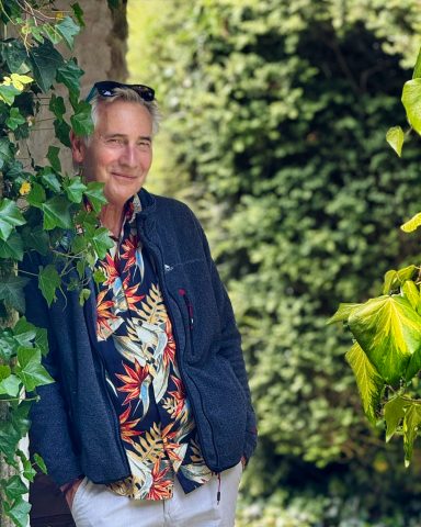 Mature lifestyle model posing confidently outdoors in patterned shirt
